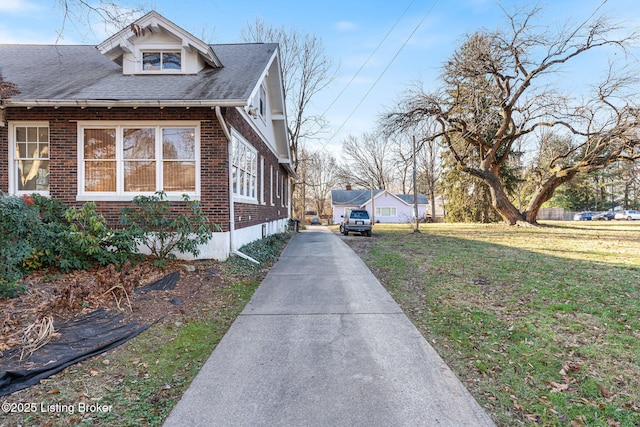 view of property exterior featuring a lawn