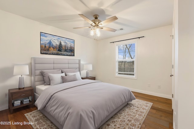 bedroom featuring ceiling fan and dark hardwood / wood-style floors