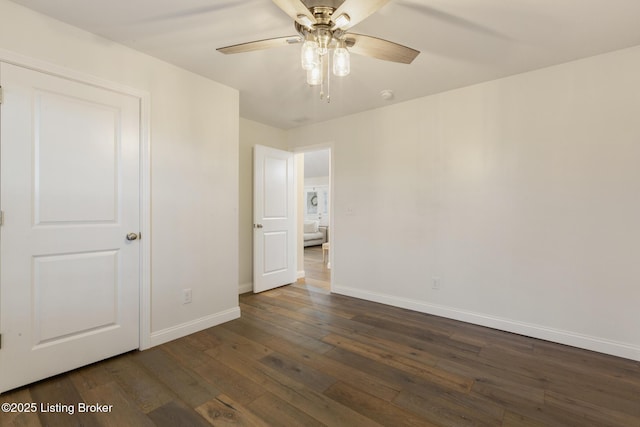 unfurnished bedroom with ceiling fan and dark hardwood / wood-style flooring