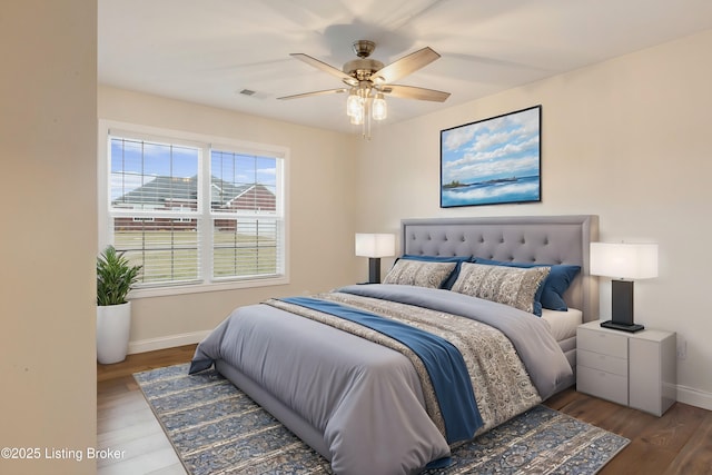 bedroom featuring wood-type flooring and ceiling fan