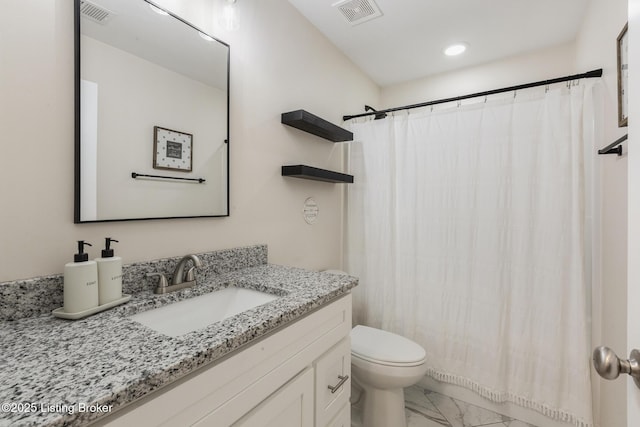 bathroom featuring vanity, toilet, and walk in shower