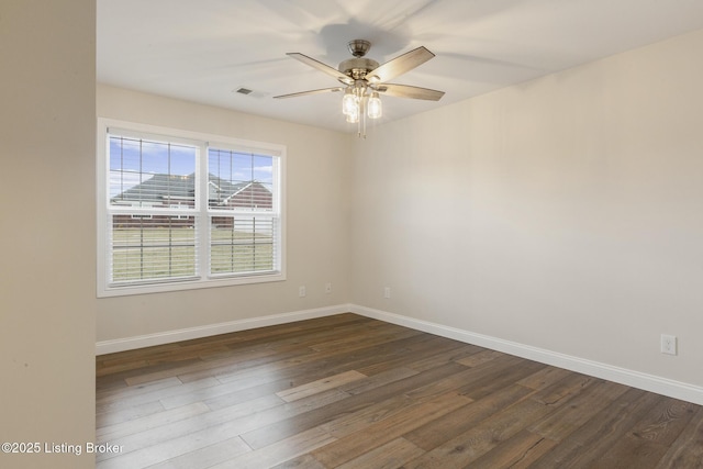 unfurnished room with dark wood-type flooring and ceiling fan