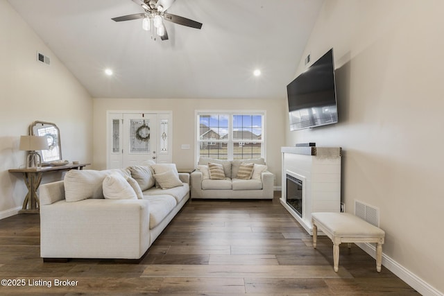 living room featuring lofted ceiling, dark hardwood / wood-style flooring, and ceiling fan