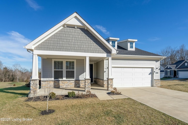 craftsman house with stone siding, a porch, concrete driveway, and an attached garage