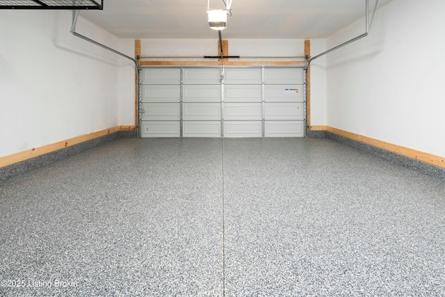 garage with baseboards and a garage door opener