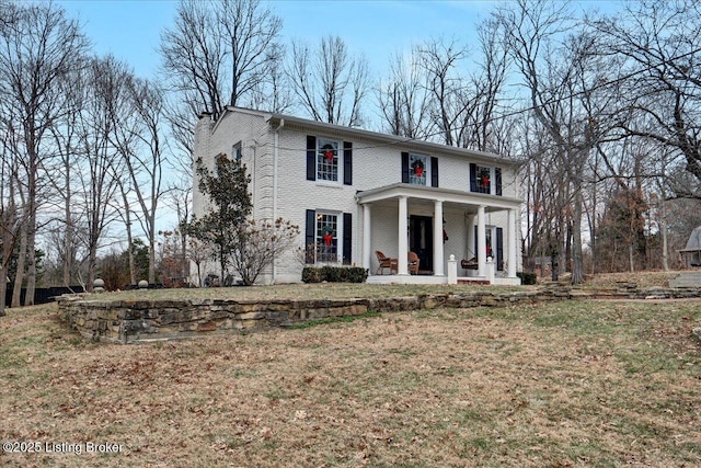 view of front of home featuring a front yard and covered porch