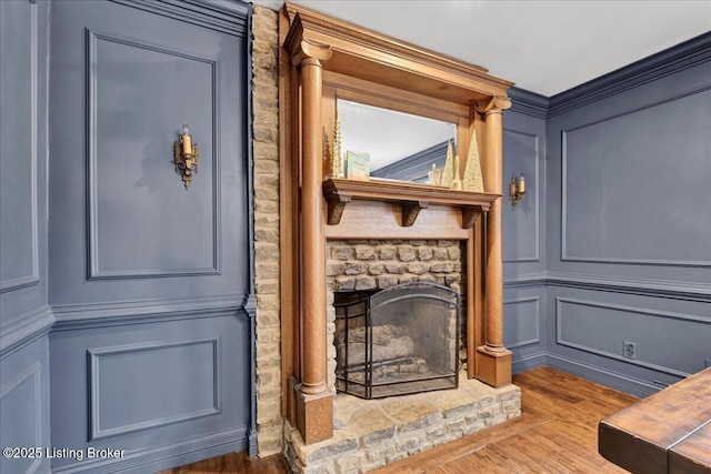 interior details featuring hardwood / wood-style flooring and a fireplace