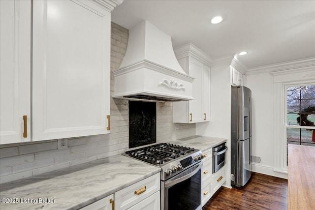 kitchen featuring stainless steel appliances, custom exhaust hood, and white cabinets