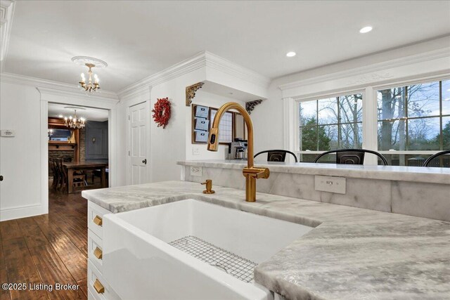 kitchen featuring a notable chandelier, crown molding, a wealth of natural light, and sink