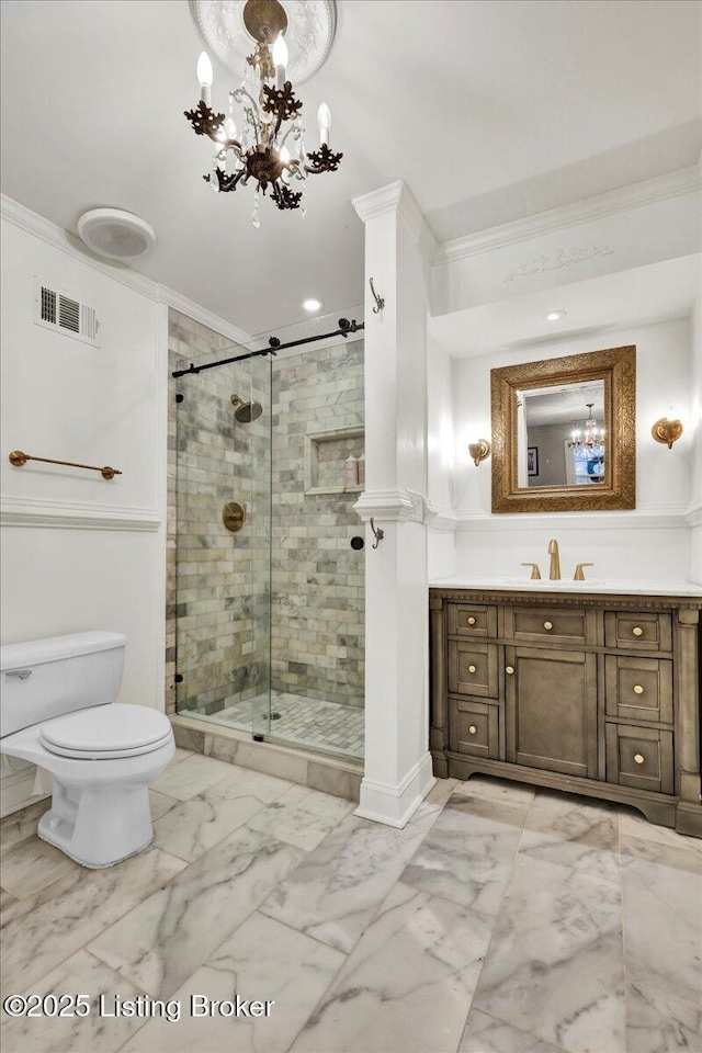 bathroom with crown molding, an inviting chandelier, walk in shower, and vanity