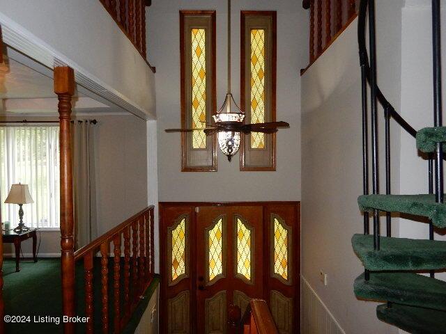 stairs featuring a towering ceiling