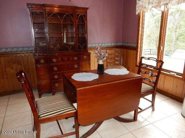 tiled dining area with wood walls