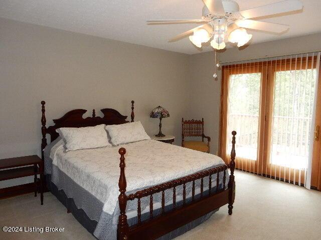 bedroom featuring multiple windows, access to exterior, ceiling fan, and carpet