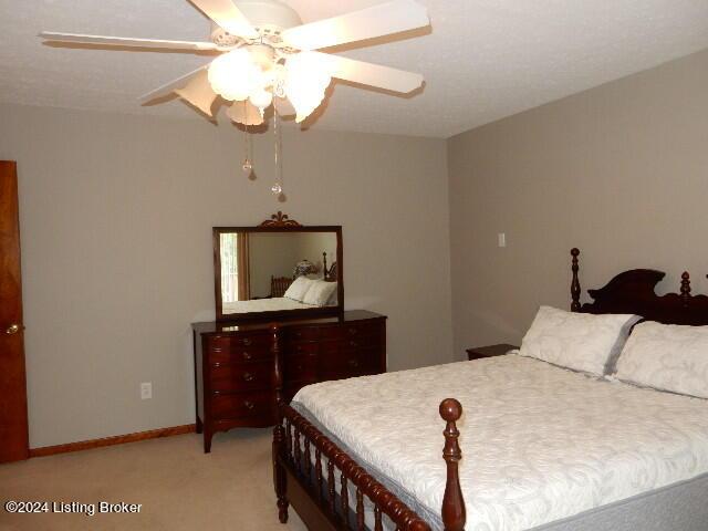 bedroom with light carpet and ceiling fan