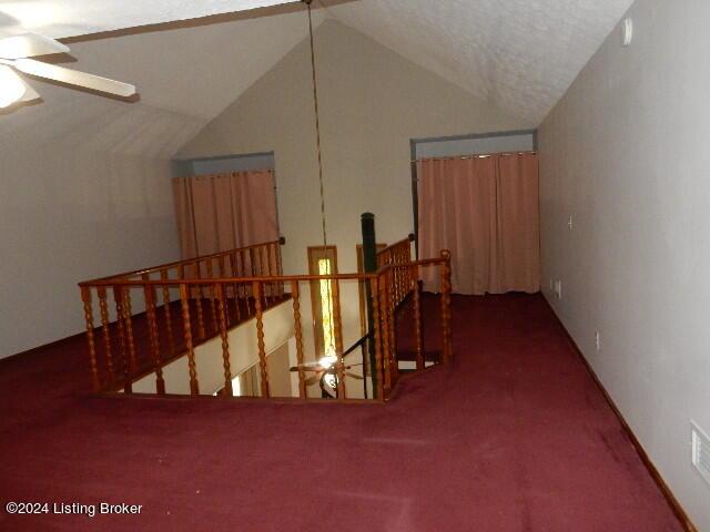 bonus room with lofted ceiling and ceiling fan