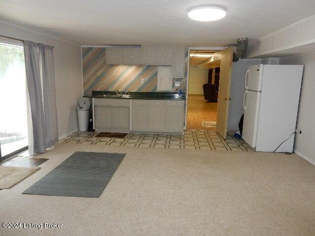 kitchen with white refrigerator and gray cabinets