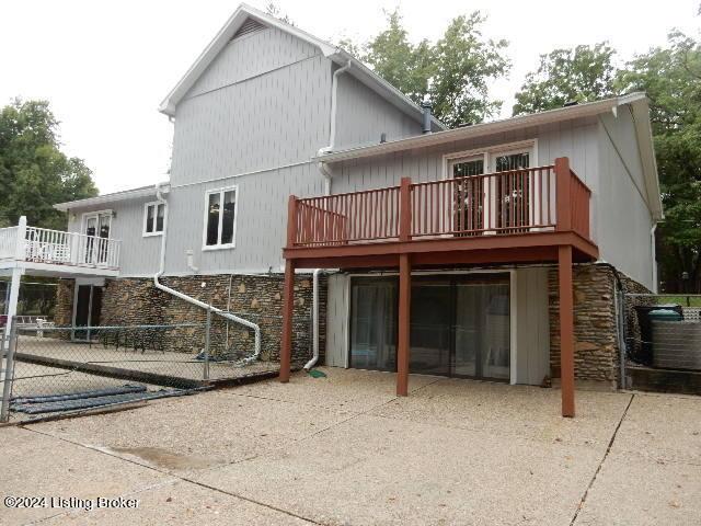 rear view of house featuring a patio area and a deck