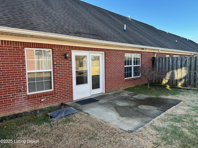 rear view of property featuring a yard and a patio