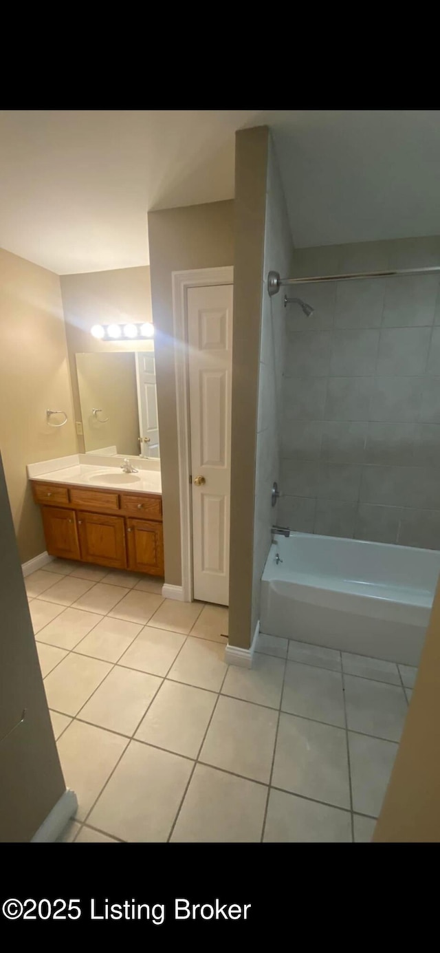 bathroom with tiled shower / bath, tile patterned floors, and vanity