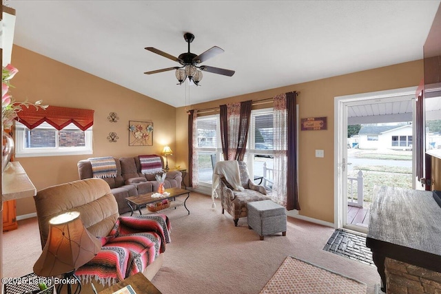 living room with vaulted ceiling, a healthy amount of sunlight, light carpet, and ceiling fan