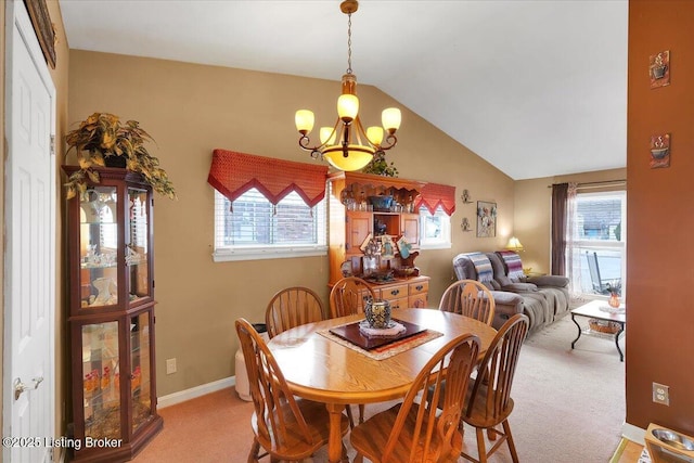 carpeted dining area featuring vaulted ceiling and a notable chandelier