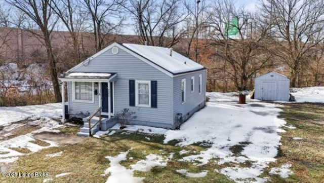 bungalow-style home featuring a storage shed