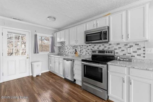 kitchen with white cabinetry, stainless steel appliances, dark wood-type flooring, and backsplash