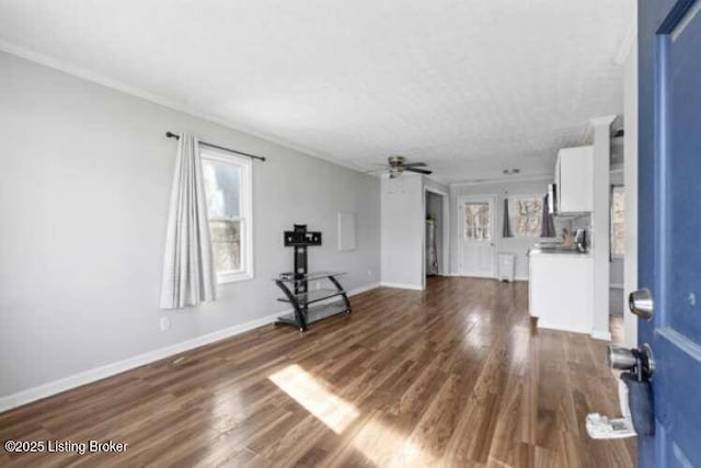 unfurnished living room featuring ceiling fan and dark hardwood / wood-style floors