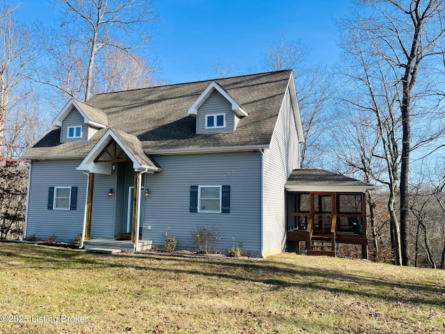 view of front of home with a sunroom and a front yard