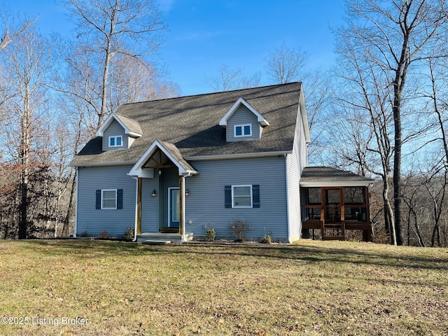 view of front facade featuring a front yard and a sunroom