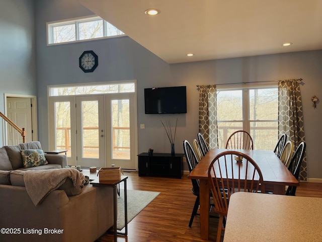 dining room with a towering ceiling and hardwood / wood-style floors