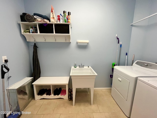 washroom with separate washer and dryer and light tile patterned floors