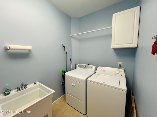 washroom featuring sink, cabinets, independent washer and dryer, and light tile patterned flooring