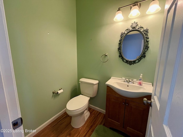 bathroom with vanity, hardwood / wood-style floors, and toilet