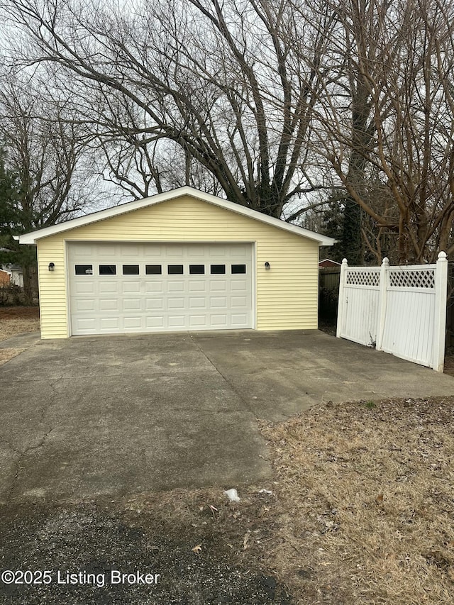 detached garage featuring fence