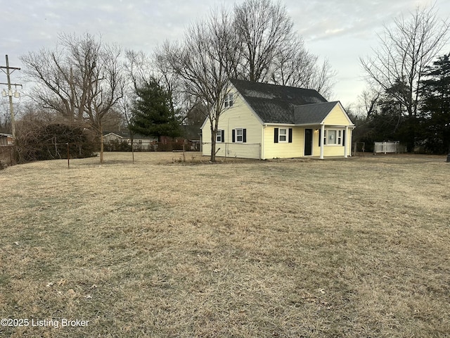 exterior space featuring fence and a front lawn