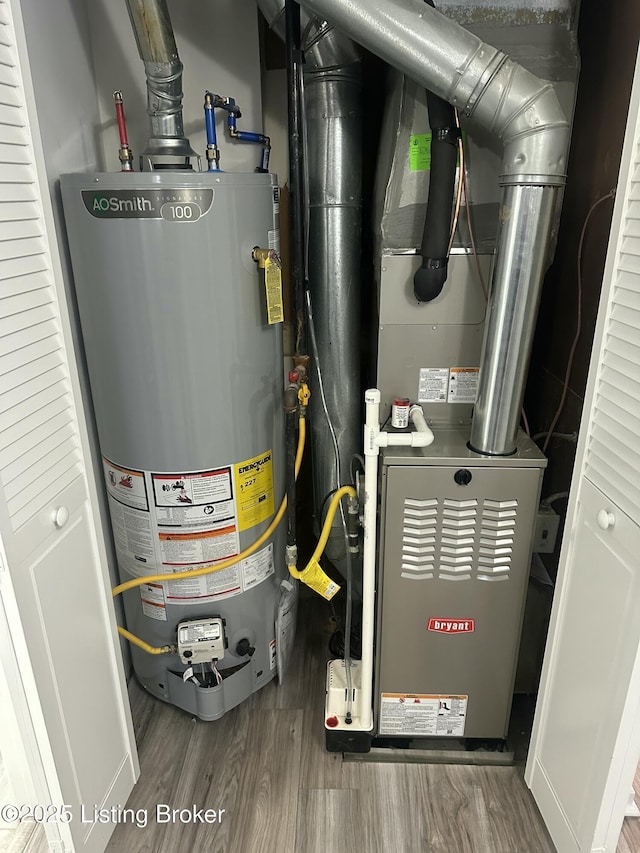 utility room with water heater and heating unit