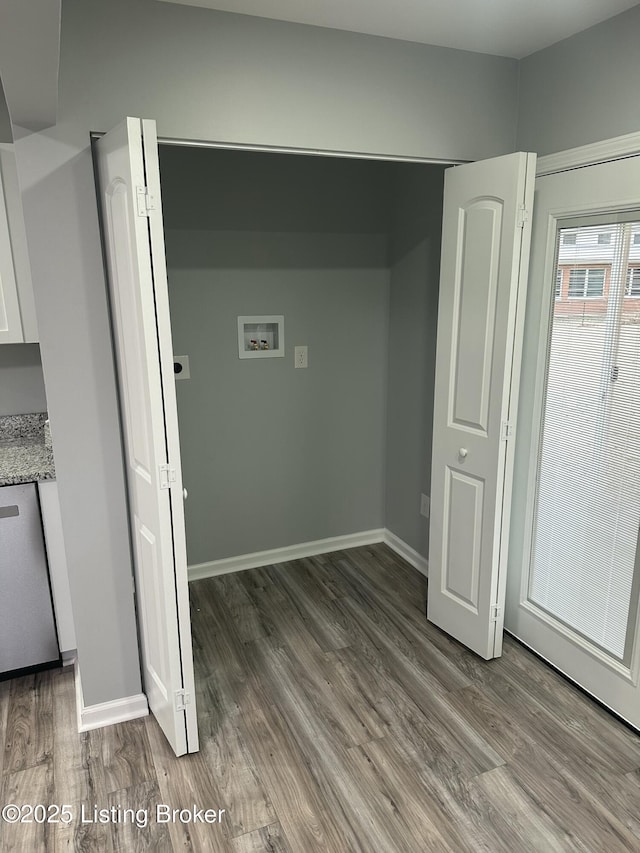 interior space featuring laundry area, hookup for a washing machine, baseboards, and wood finished floors