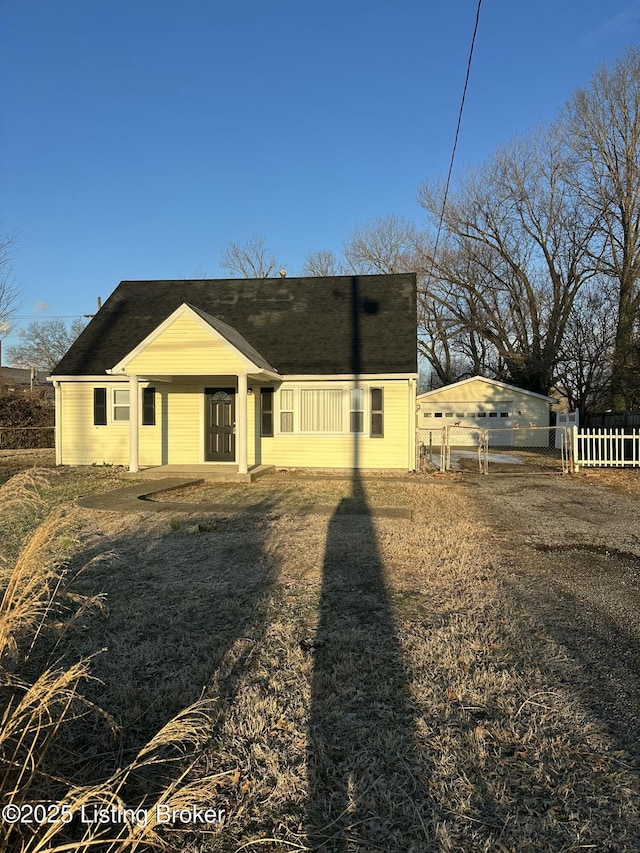 back of property featuring a gate and fence