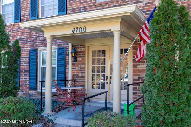 view of exterior entry with a porch