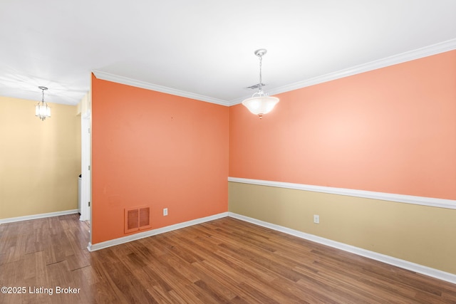 spare room with ornamental molding and hardwood / wood-style floors