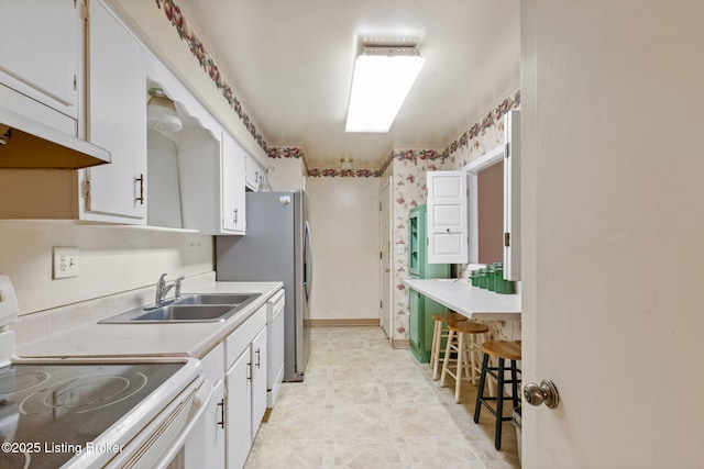 kitchen with white cabinetry, dishwasher, sink, and stove