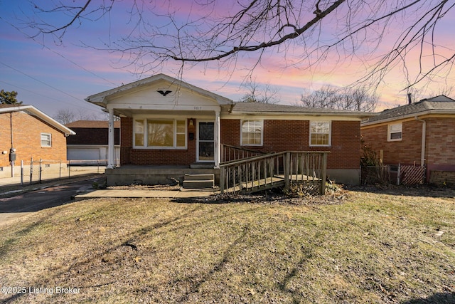 view of front of home with a porch and a yard