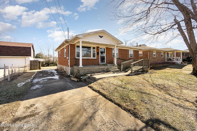 bungalow featuring a front lawn and covered porch