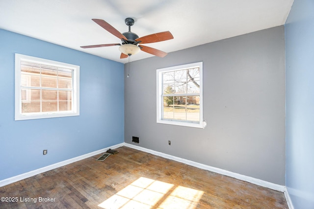 empty room featuring hardwood / wood-style floors and ceiling fan