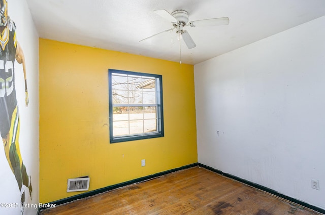 spare room featuring hardwood / wood-style floors and ceiling fan