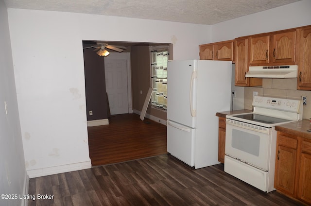 kitchen with white appliances, ceiling fan, dark hardwood / wood-style floors, a textured ceiling, and decorative backsplash