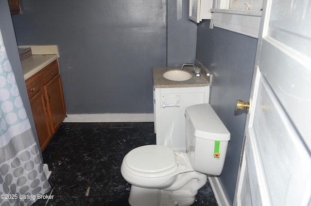 bathroom featuring vanity and toilet