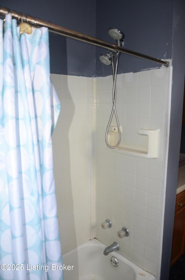 bathroom with shower / bath combo with shower curtain