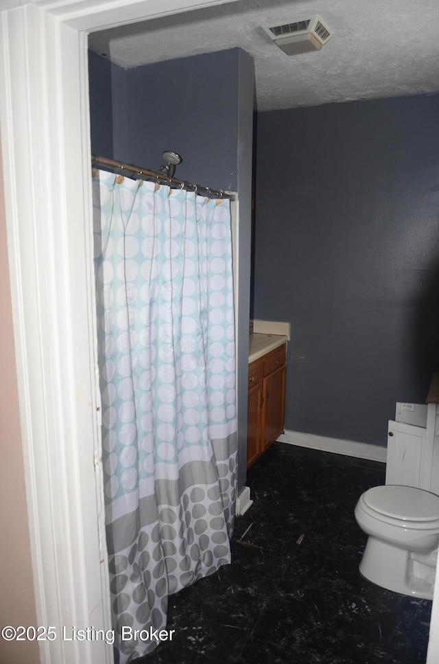 bathroom with vanity and a textured ceiling